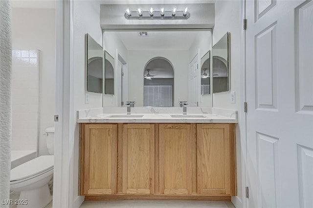 full bathroom featuring bathtub / shower combination, vanity, toilet, and ceiling fan