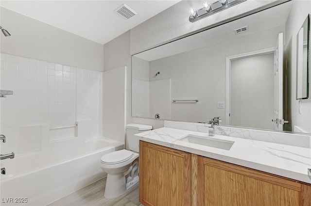 full bathroom featuring hardwood / wood-style floors, vanity, toilet, and shower / washtub combination