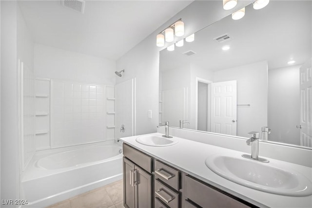 bathroom with tile patterned flooring, vanity, and tub / shower combination