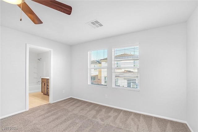 unfurnished room with light carpet and ceiling fan