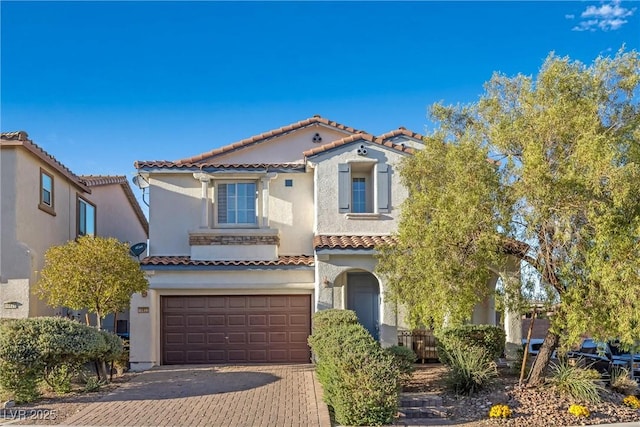 mediterranean / spanish-style home featuring a garage