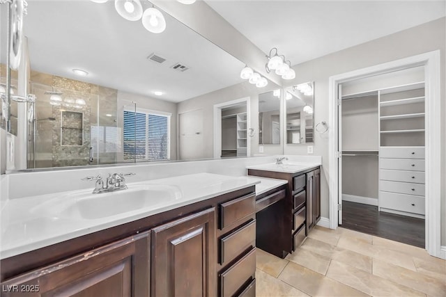 bathroom with tile patterned floors, vanity, and a shower with shower door