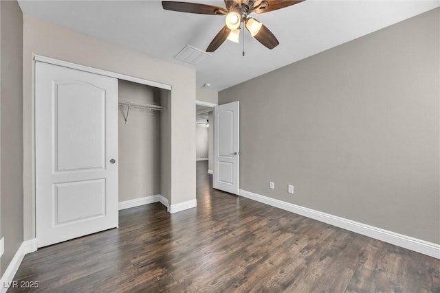 unfurnished bedroom featuring ceiling fan, dark wood-type flooring, and a closet