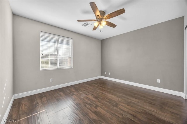 empty room featuring ceiling fan and dark hardwood / wood-style flooring