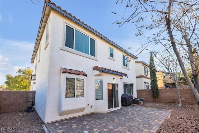 rear view of property featuring cooling unit and a patio