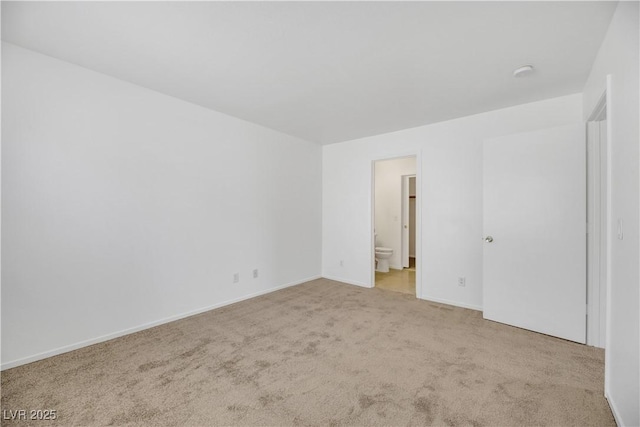 unfurnished room featuring light carpet