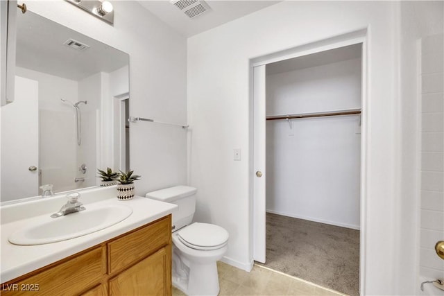 bathroom featuring a shower, vanity, and toilet