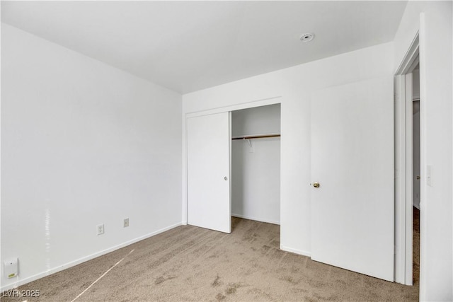 unfurnished bedroom featuring a closet and carpet floors