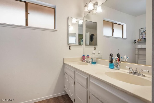 3609 Woodglen Ct, Las Vegas, NV 89108 - bathroom with double vanity and wood finished floors