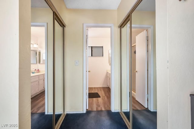 3609 Woodglen Ct, Las Vegas, NV 89108 - hall featuring dark wood-style floors and baseboards