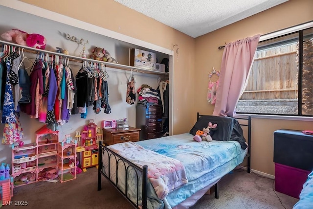 carpeted bedroom with a textured ceiling and a closet