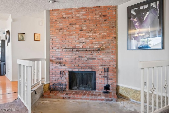 living room featuring a fireplace and a textured ceiling