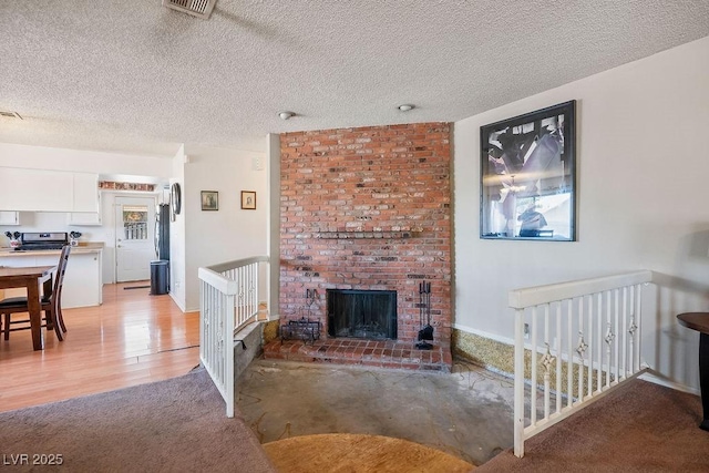 3609 Woodglen Ct, Las Vegas, NV 89108 - living area featuring a textured ceiling, light wood-style flooring, and a brick fireplace