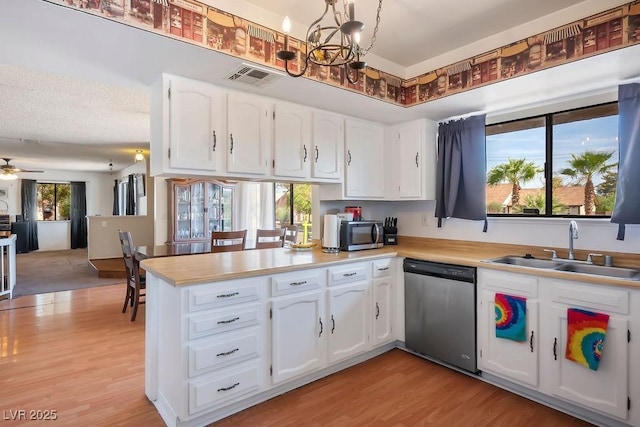 kitchen with white cabinetry, sink, kitchen peninsula, ceiling fan with notable chandelier, and appliances with stainless steel finishes