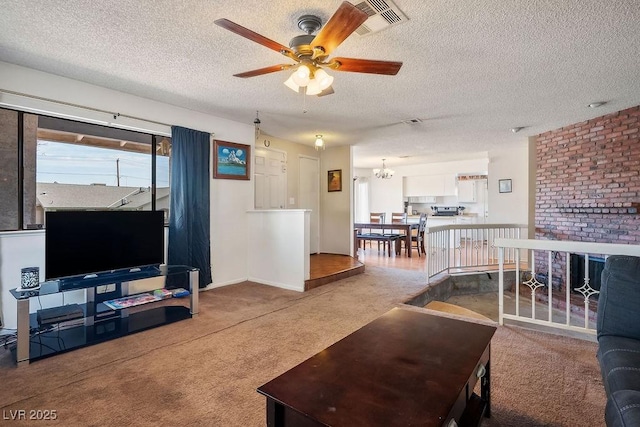 carpeted living room with ceiling fan with notable chandelier and a textured ceiling