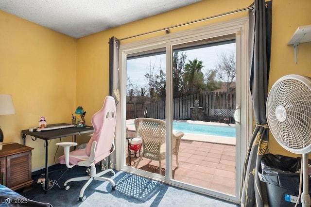 doorway to outside featuring a textured ceiling