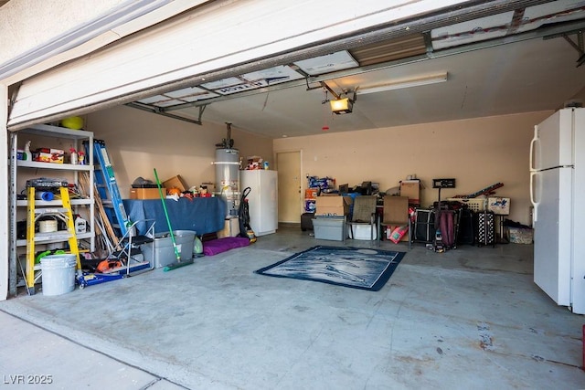 garage featuring secured water heater, white fridge, a garage door opener, and water heater