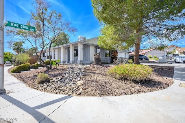 3609 Woodglen Ct, Las Vegas, NV 89108 - view of front of home featuring an attached garage and a chimney