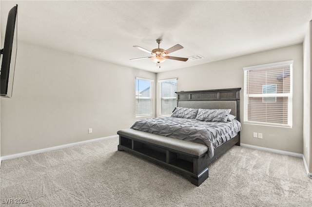 bedroom featuring light colored carpet and ceiling fan