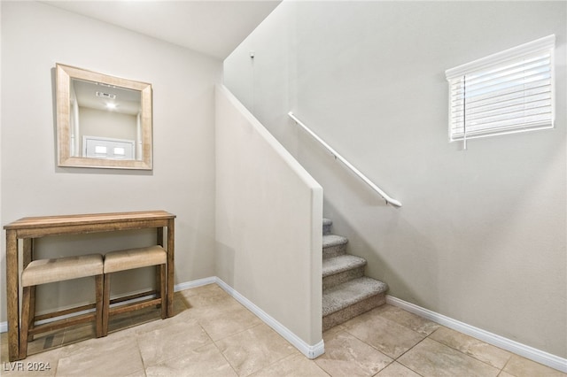 staircase with tile patterned floors