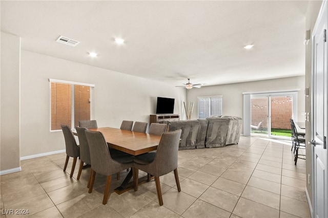 tiled dining space with ceiling fan