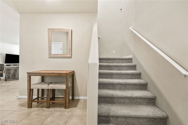 stairs featuring tile patterned flooring