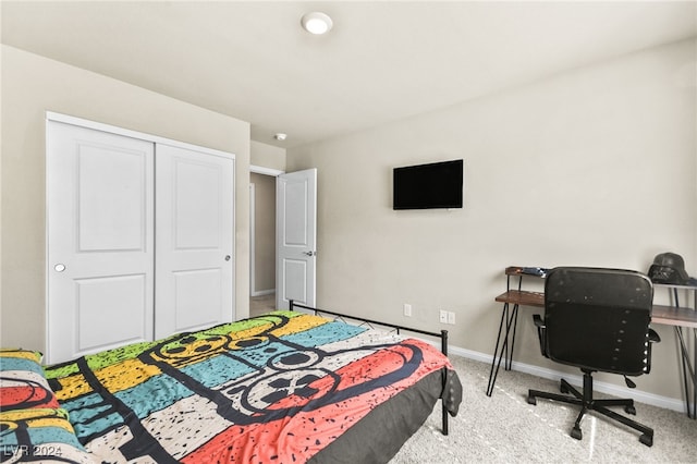 bedroom featuring light colored carpet and a closet