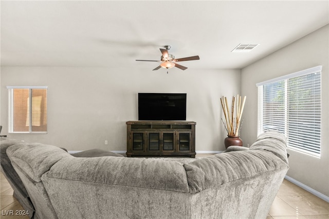 tiled living room featuring ceiling fan