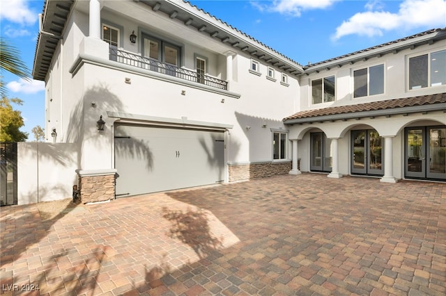 exterior space with a garage and a balcony