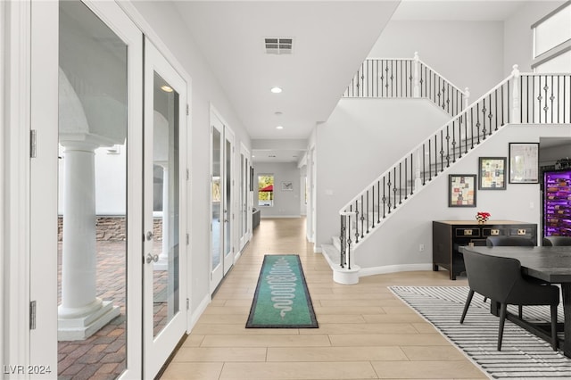 entrance foyer featuring light wood-type flooring and french doors