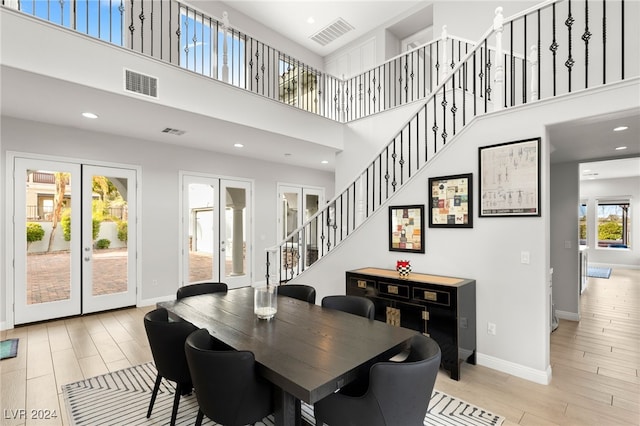 dining room with french doors and a high ceiling