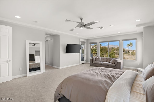 bedroom featuring light carpet and ceiling fan