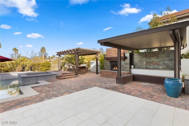 view of patio / terrace featuring an in ground hot tub and an outdoor kitchen