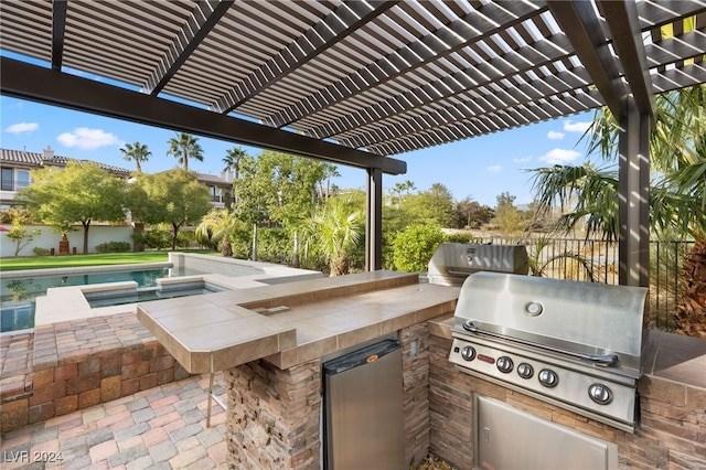 view of patio / terrace featuring a pergola, a grill, and exterior kitchen