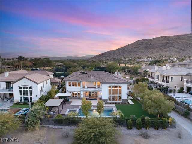 aerial view at dusk featuring a mountain view