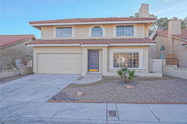 mediterranean / spanish-style house with a garage