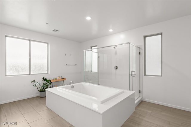 bathroom with separate shower and tub