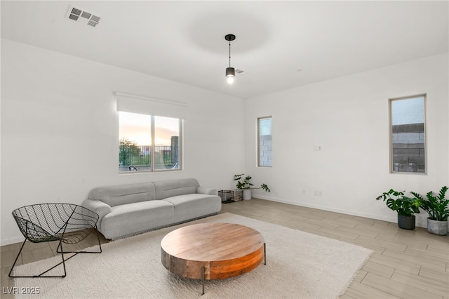 living room featuring light hardwood / wood-style floors and a healthy amount of sunlight