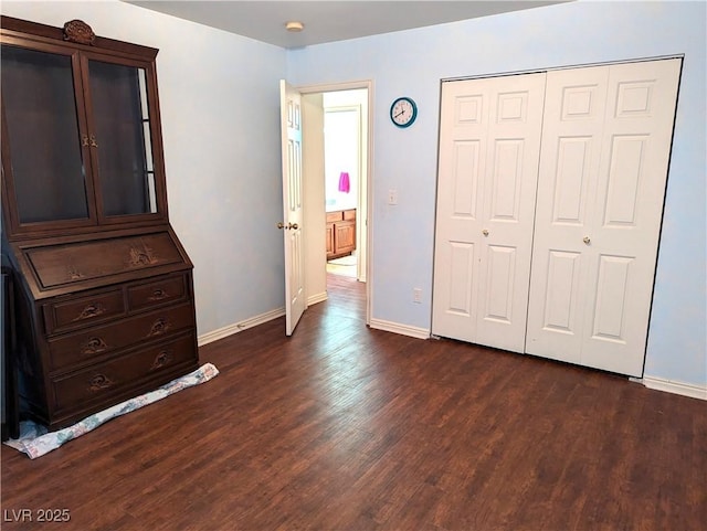 2327 Iron Dr, Ely, NV 89301 - unfurnished bedroom featuring dark wood-style flooring, baseboards, and a closet