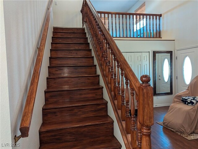 2327 Iron Dr, Ely, NV 89301 - staircase with wood finished floors, a high ceiling, and baseboards