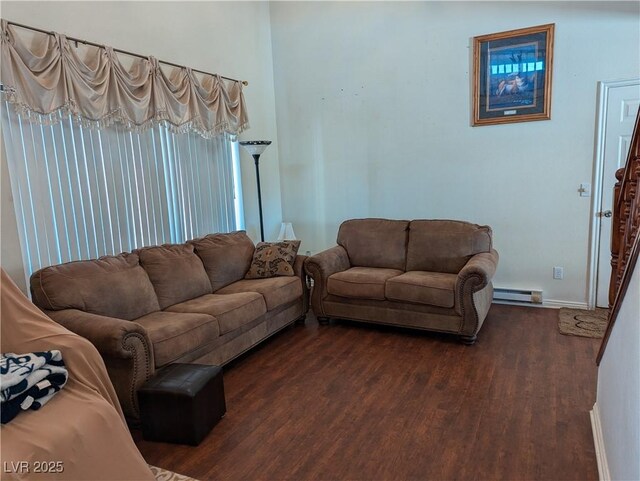 living room with dark hardwood / wood-style flooring and a baseboard heating unit