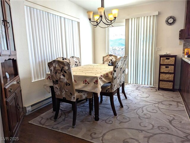 dining space featuring a notable chandelier and baseboard heating