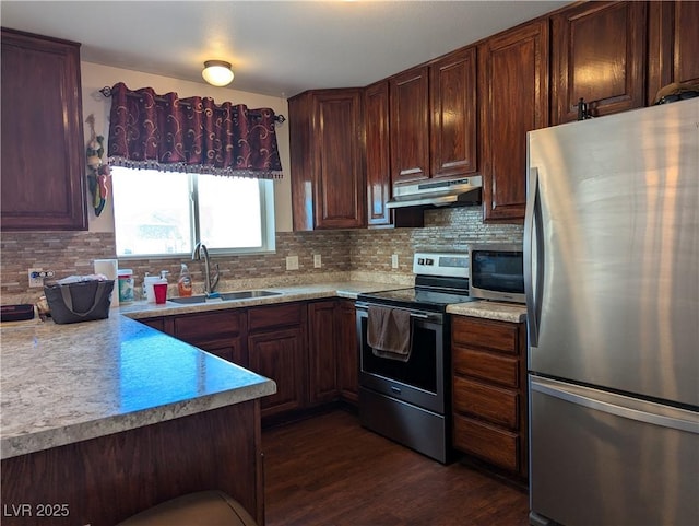 2327 Iron Dr, Ely, NV 89301 - kitchen featuring appliances with stainless steel finishes, under cabinet range hood, a sink, and light countertops