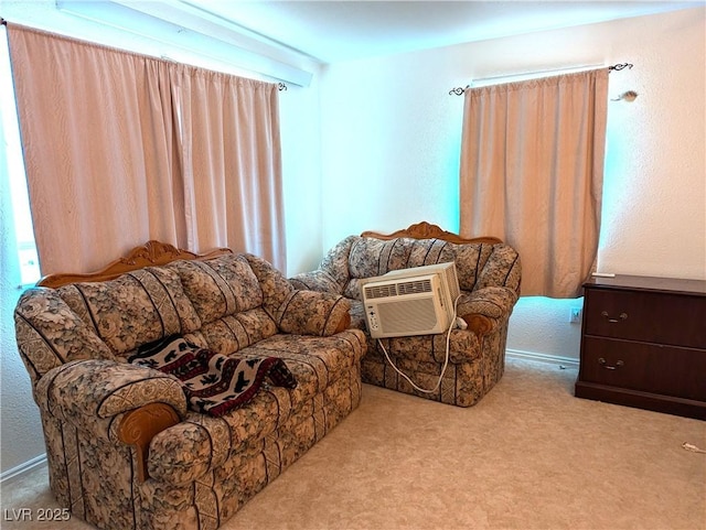 sitting room with light carpet and an AC wall unit