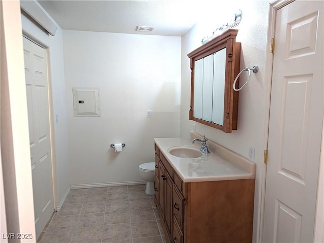 bathroom featuring vanity, electric panel, and toilet