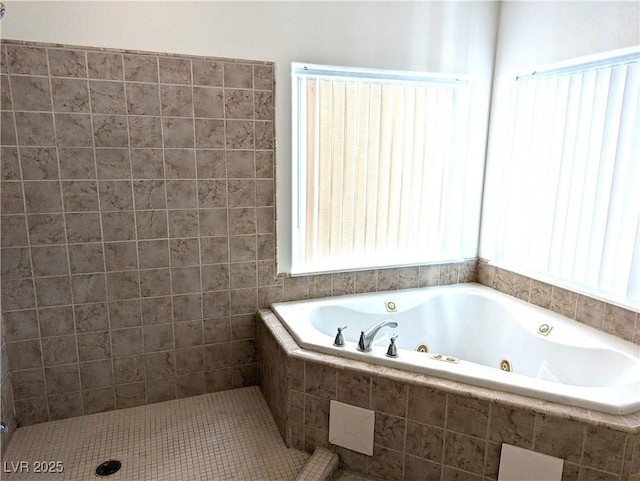 bathroom featuring tiled tub