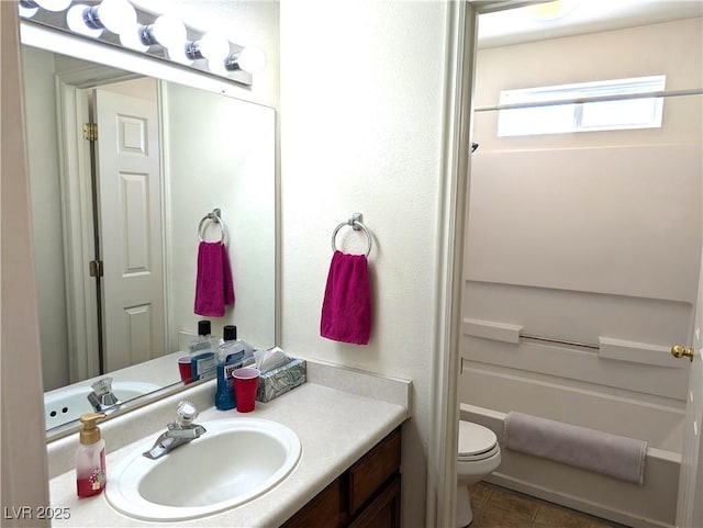 bathroom featuring vanity, tile patterned floors, and toilet