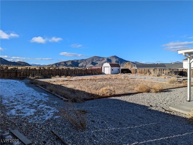 2327 Iron Dr, Ely, NV 89301 - view of yard featuring a storage unit, an outbuilding, a mountain view, and fence