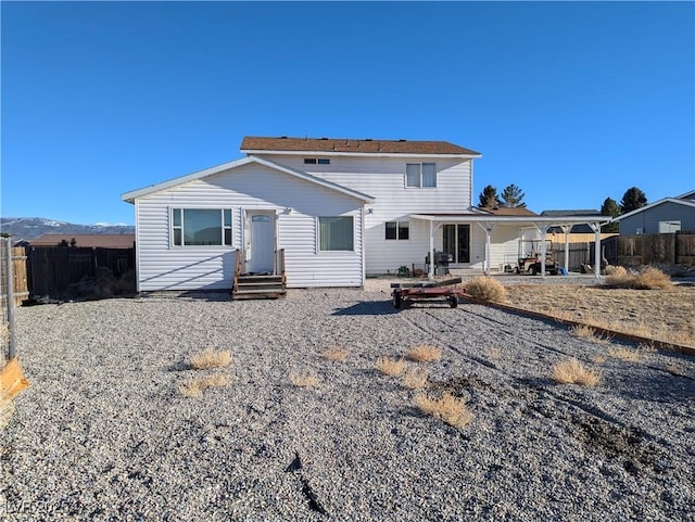 rear view of property featuring a mountain view