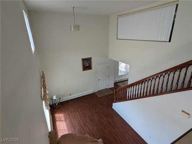 2327 Iron Dr, Ely, NV 89301 - foyer entrance with wood finished floors, stairs, baseboards, and a baseboard radiator